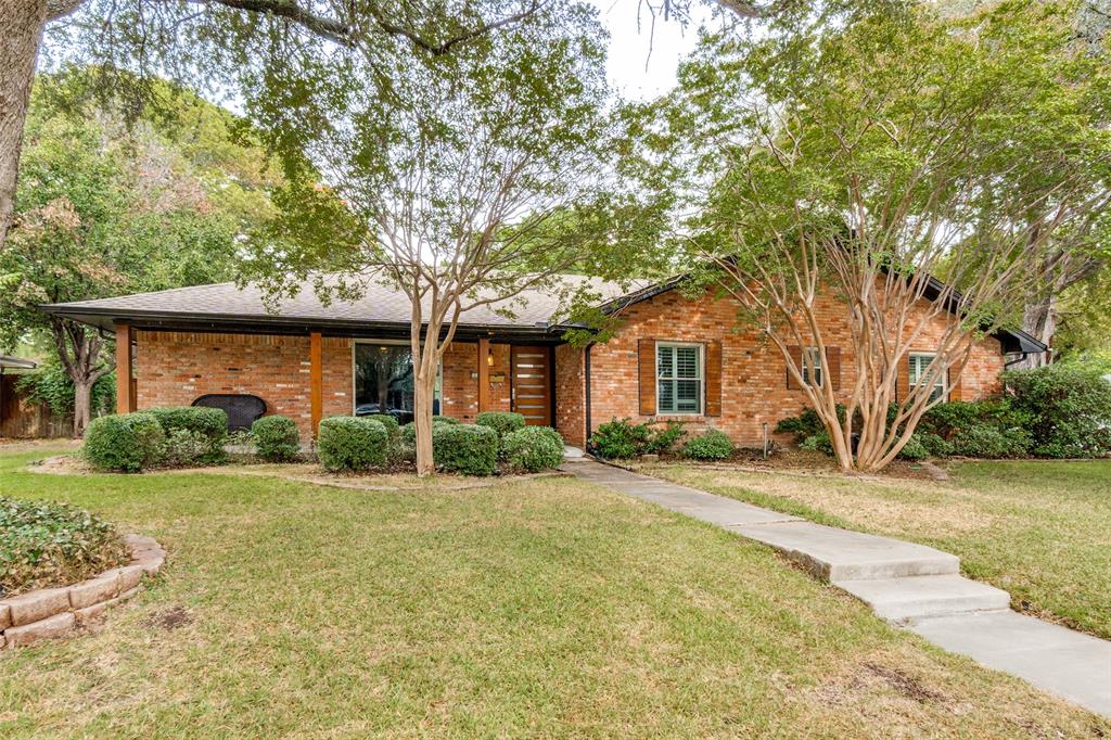 10355 Carry Back Circle Dallas, TX 75229 - Photo 5 of 35 a front view of a house with a yard and garage