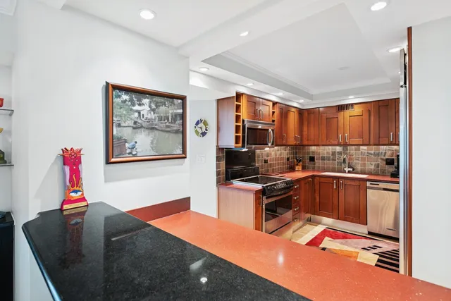 a kitchen that has a sink and a stove in it