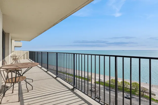 a balcony with table and chairs