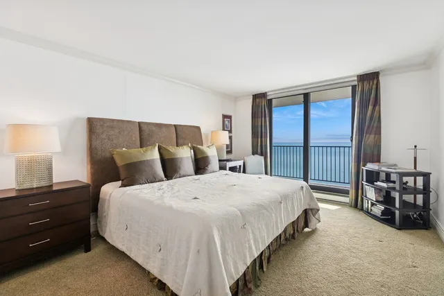 a spacious bedroom with a bed and a table