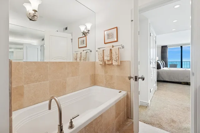 a en suite bathroom with a granite countertop sink