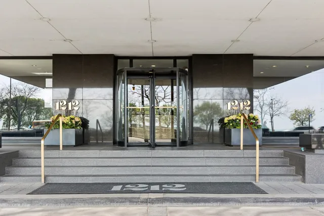 a view of living room with floor to ceiling window and outdoor kitchen
