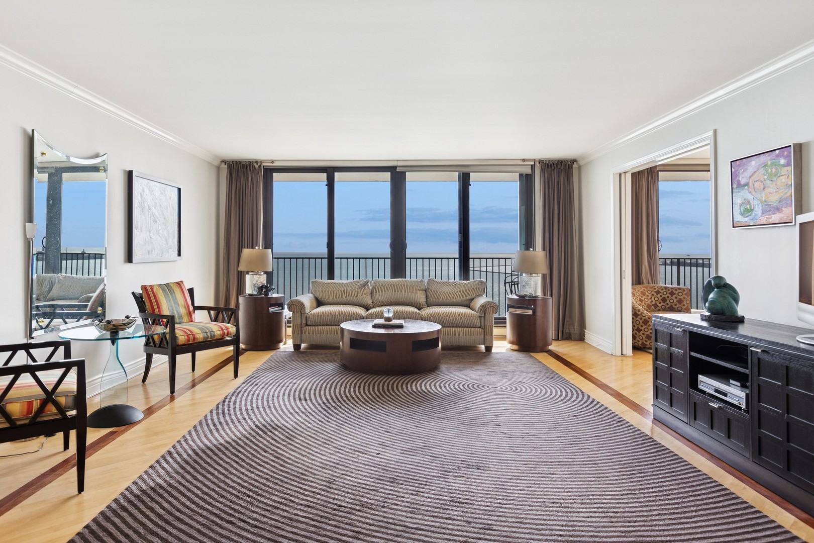 1212 North Lake Shore Drive, Unit 16BS Chicago, IL 60610 - Photo 7 of 26 a living room with furniture and large windows