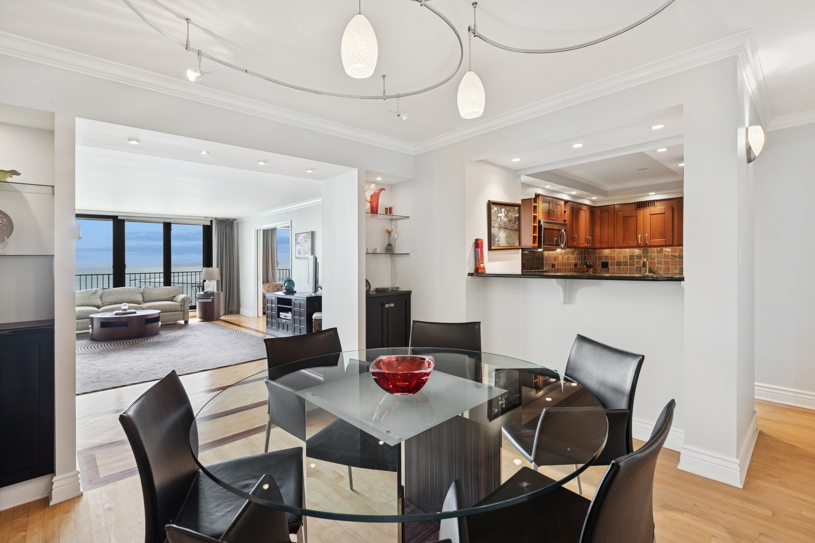 1212 North Lake Shore Drive, Unit 16BS Chicago, IL 60610 - Photo 10 of 26 a view of a dining room and livingroom with furniture wooden floor a rug and a chandelier