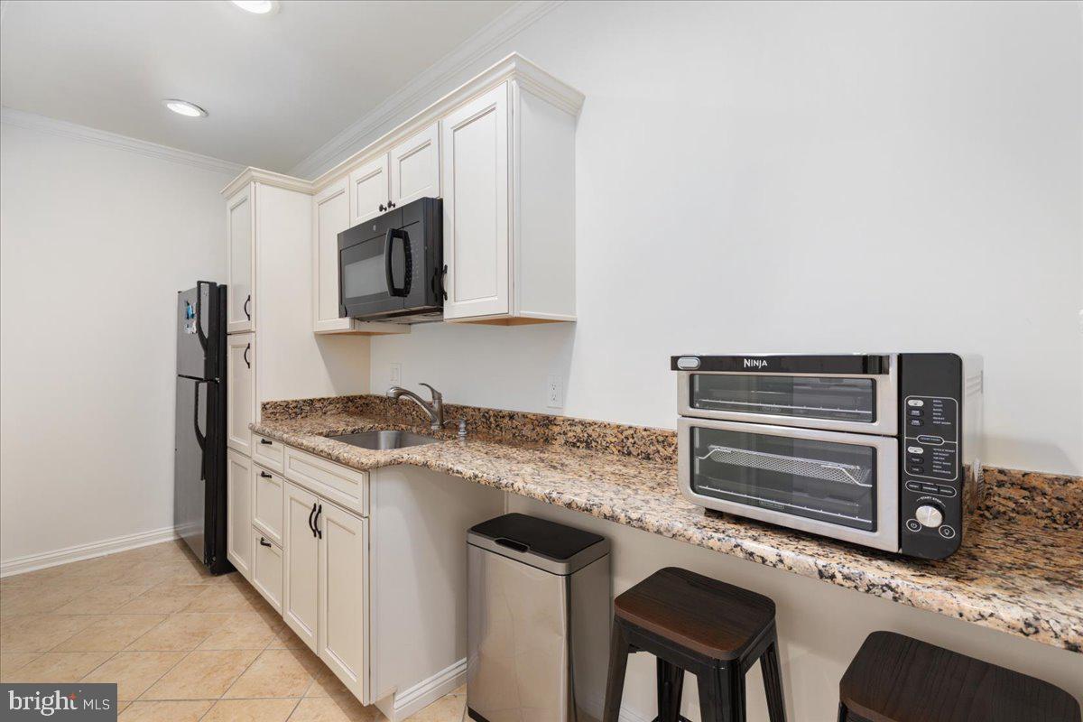 14915 Alpine Bay Loop Gainesville, VA 20155 - Photo 72 of 105 a kitchen with stainless steel appliances granite countertop a stove microwave and oven