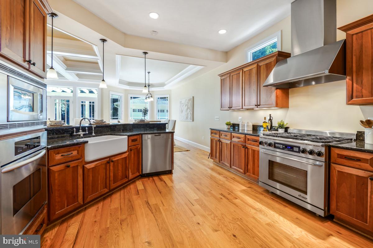 217 Talahi Road Southeast Vienna, VA 22180 - Photo 22 of 63 a kitchen with stainless steel appliances granite countertop a stove a sink and a refrigerator