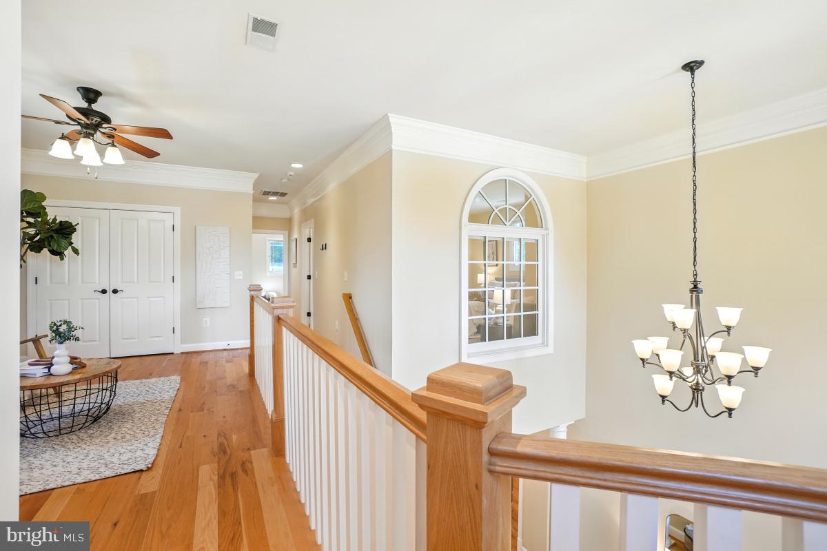217 Talahi Road Southeast Vienna, VA 22180 - Photo 36 of 63 a view of a livingroom with wooden floor and a chandelier