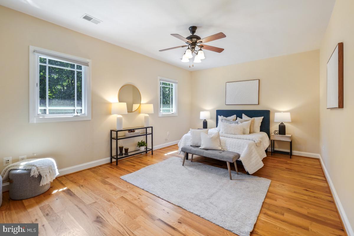 217 Talahi Road Southeast Vienna, VA 22180 - Photo 40 of 63 a bedroom with a bed wooden floor and window