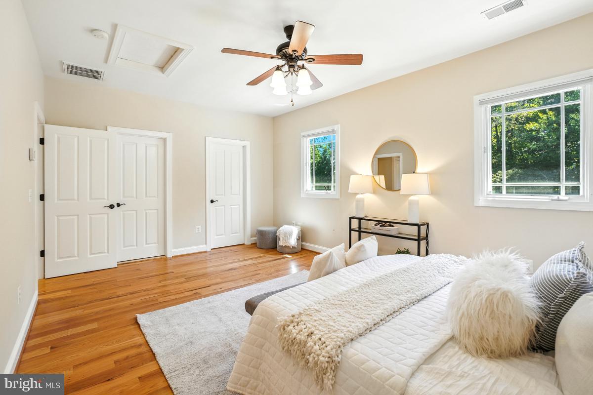 217 Talahi Road Southeast Vienna, VA 22180 - Photo 41 of 63 a bedroom with a bed and a chandelier