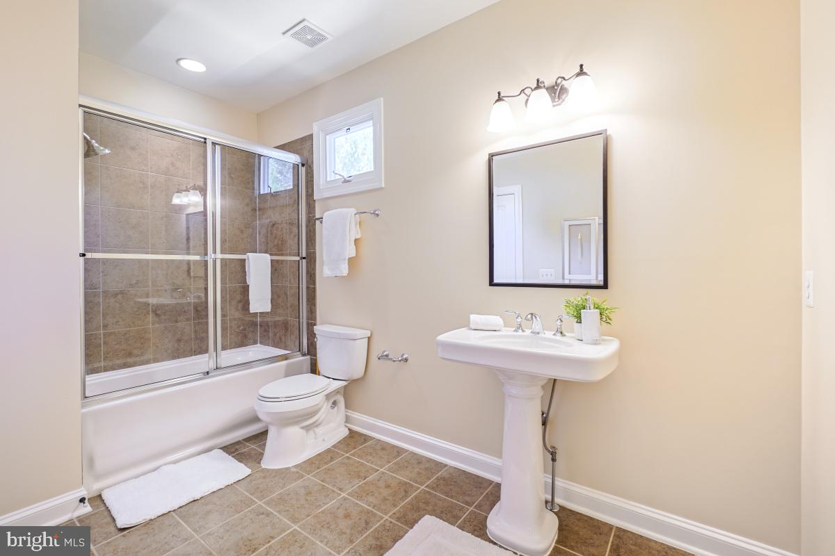 217 Talahi Road Southeast Vienna, VA 22180 - Photo 43 of 63 a bathroom with a toilet sink and mirror