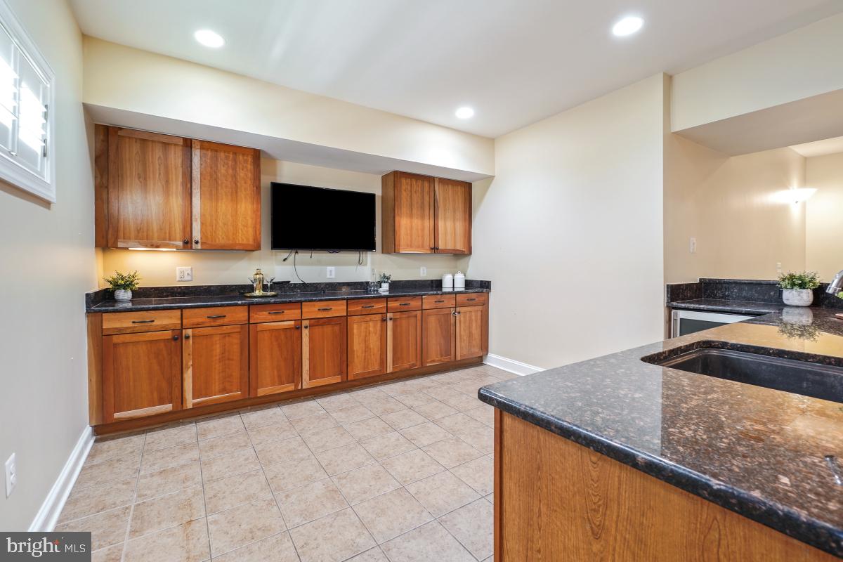 217 Talahi Road Southeast Vienna, VA 22180 - Photo 48 of 63 a kitchen with stainless steel appliances granite countertop a sink and a stove