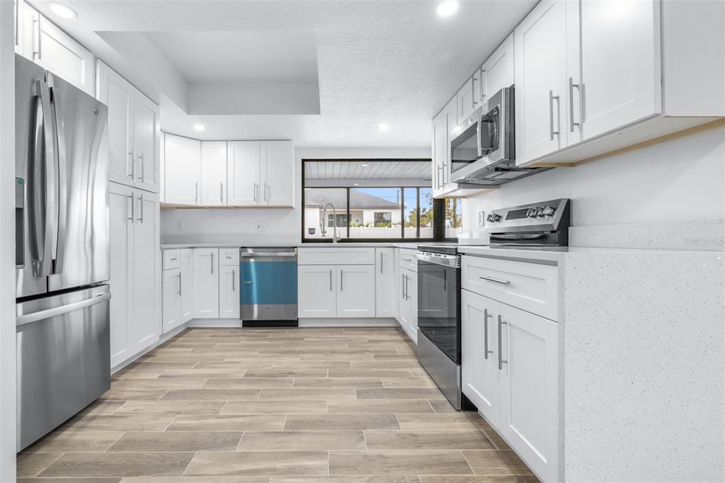 6312 Fairway Boulevard Apollo Beach, FL 33572 - Photo 11 of 58 a kitchen with stainless steel appliances granite countertop a refrigerator sink and cabinets