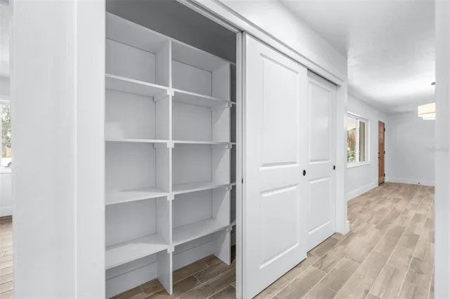 wooden floor in an empty room with a window
