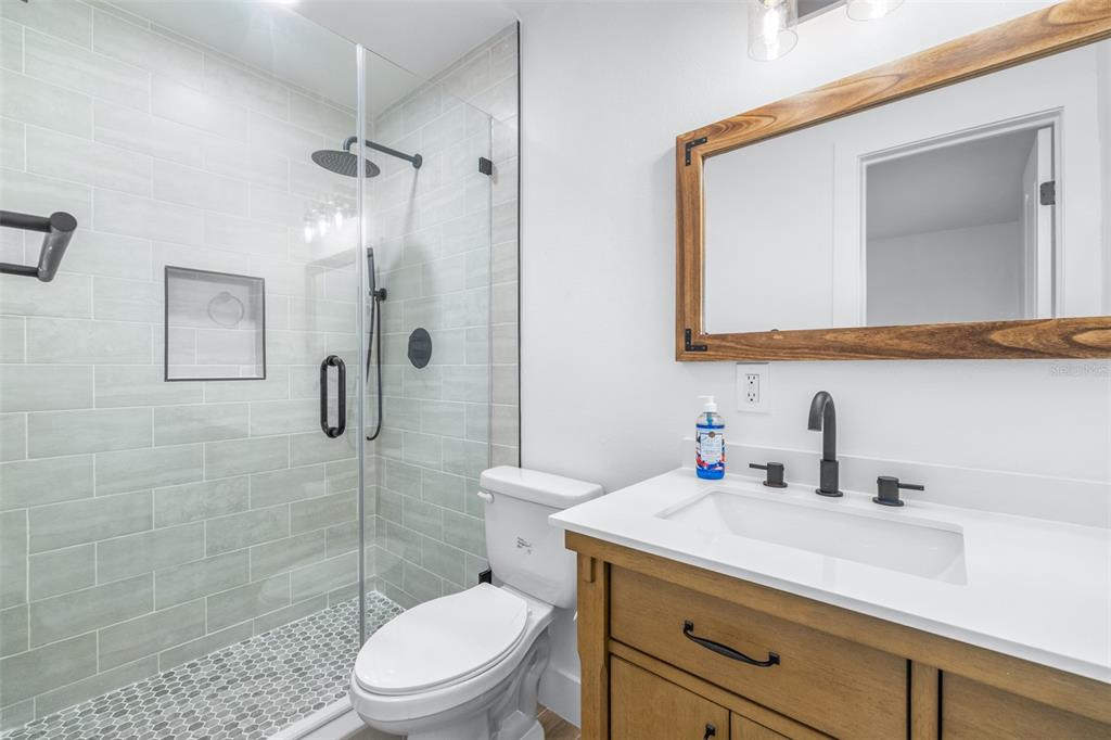 6312 Fairway Boulevard Apollo Beach, FL 33572 - Photo 22 of 58 a bathroom with a sink a toilet and shower