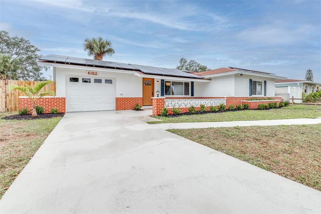 6312 Fairway Boulevard Apollo Beach, FL 33572 - Photo 3 of 58 a front view of a house with a yard and garage