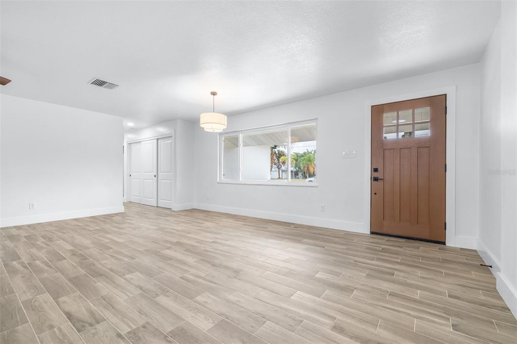 6312 Fairway Boulevard Apollo Beach, FL 33572 - Photo 6 of 58 an empty room with wooden floor and windows