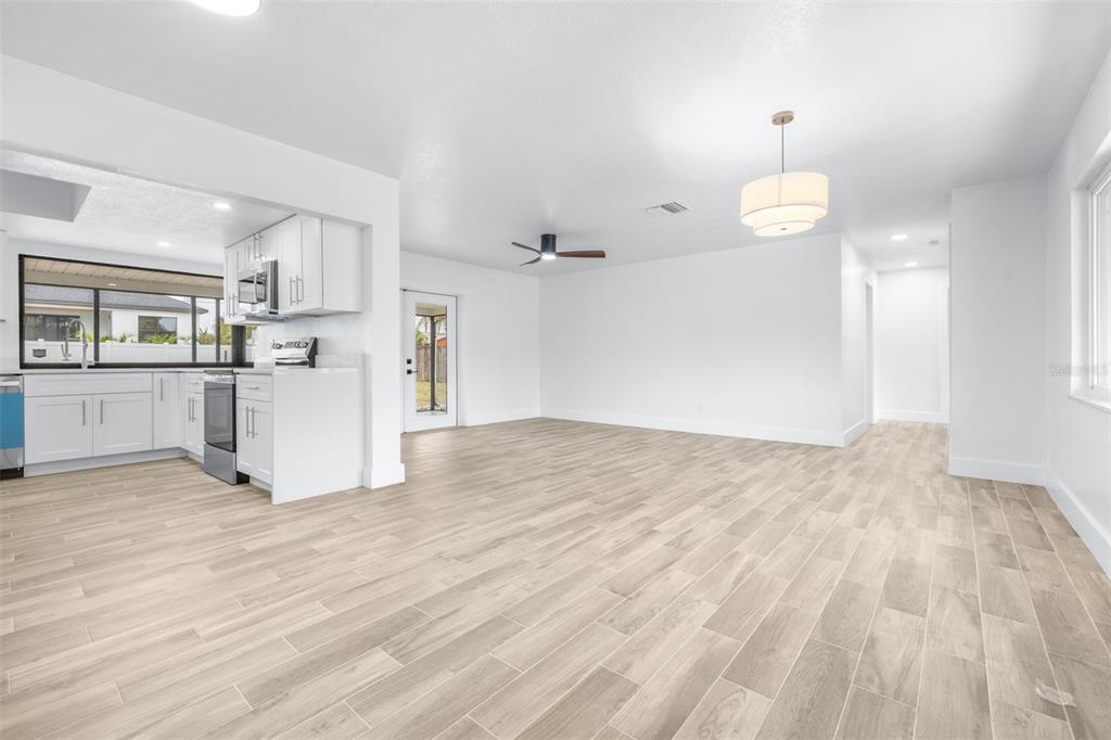 6312 Fairway Boulevard Apollo Beach, FL 33572 - Photo 7 of 58 a view of a kitchen with a sink and dishwasher a refrigerator with wooden floor