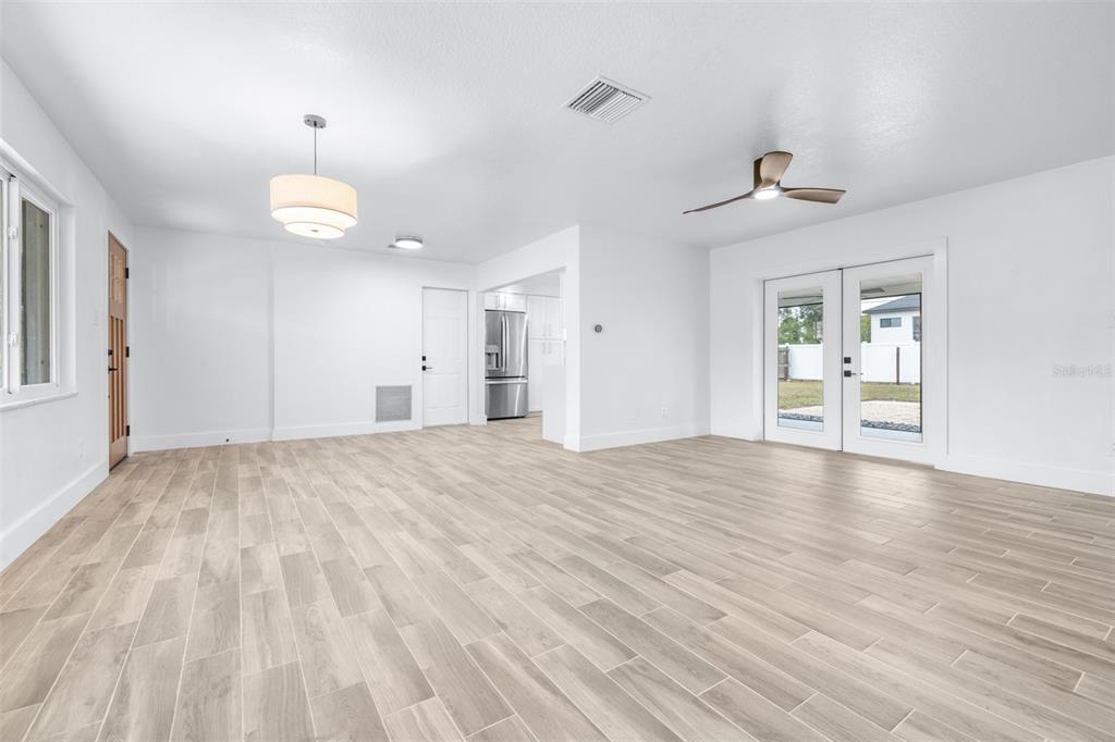 6312 Fairway Boulevard Apollo Beach, FL 33572 - Photo 9 of 58 a view of an empty room with a window and wooden floor
