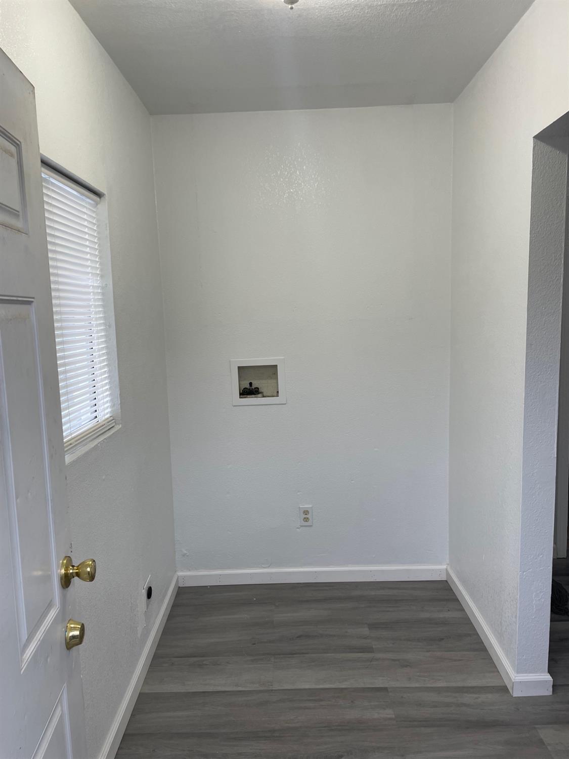 421 East Elm Street Lodi, CA 95240 - Photo 12 of 17 a view of an empty room with wooden floor and a window