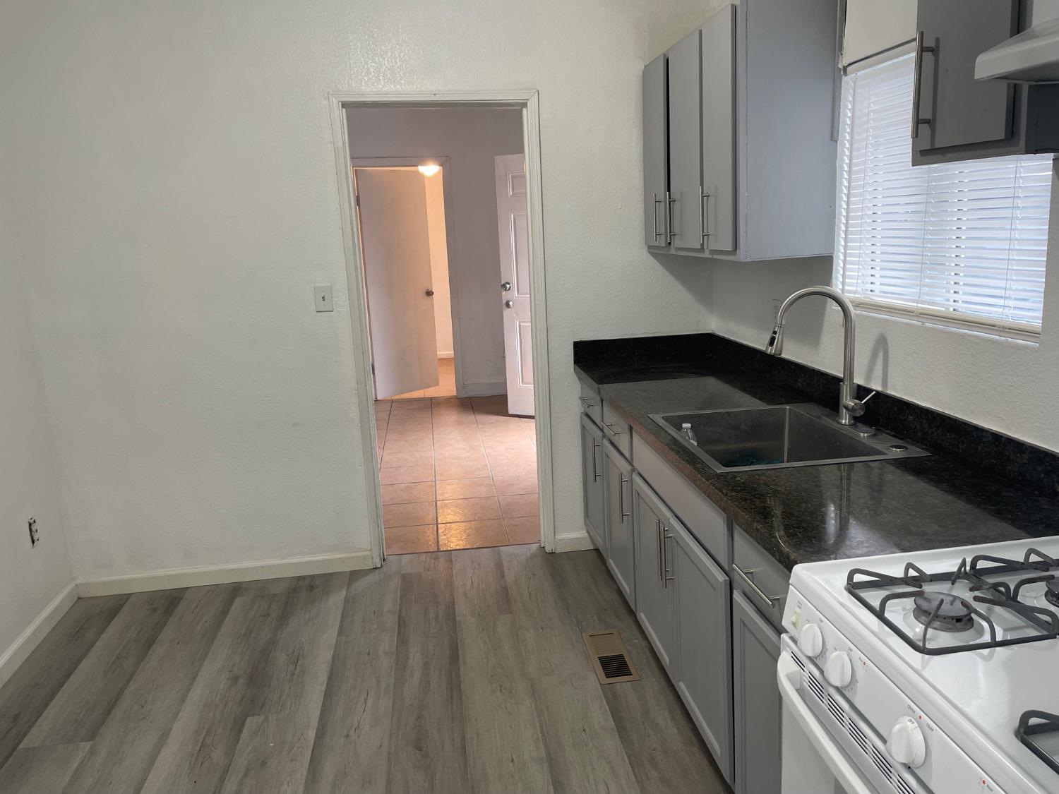 421 East Elm Street Lodi, CA 95240 - Photo 2 of 17 a kitchen that has a sink and a stove