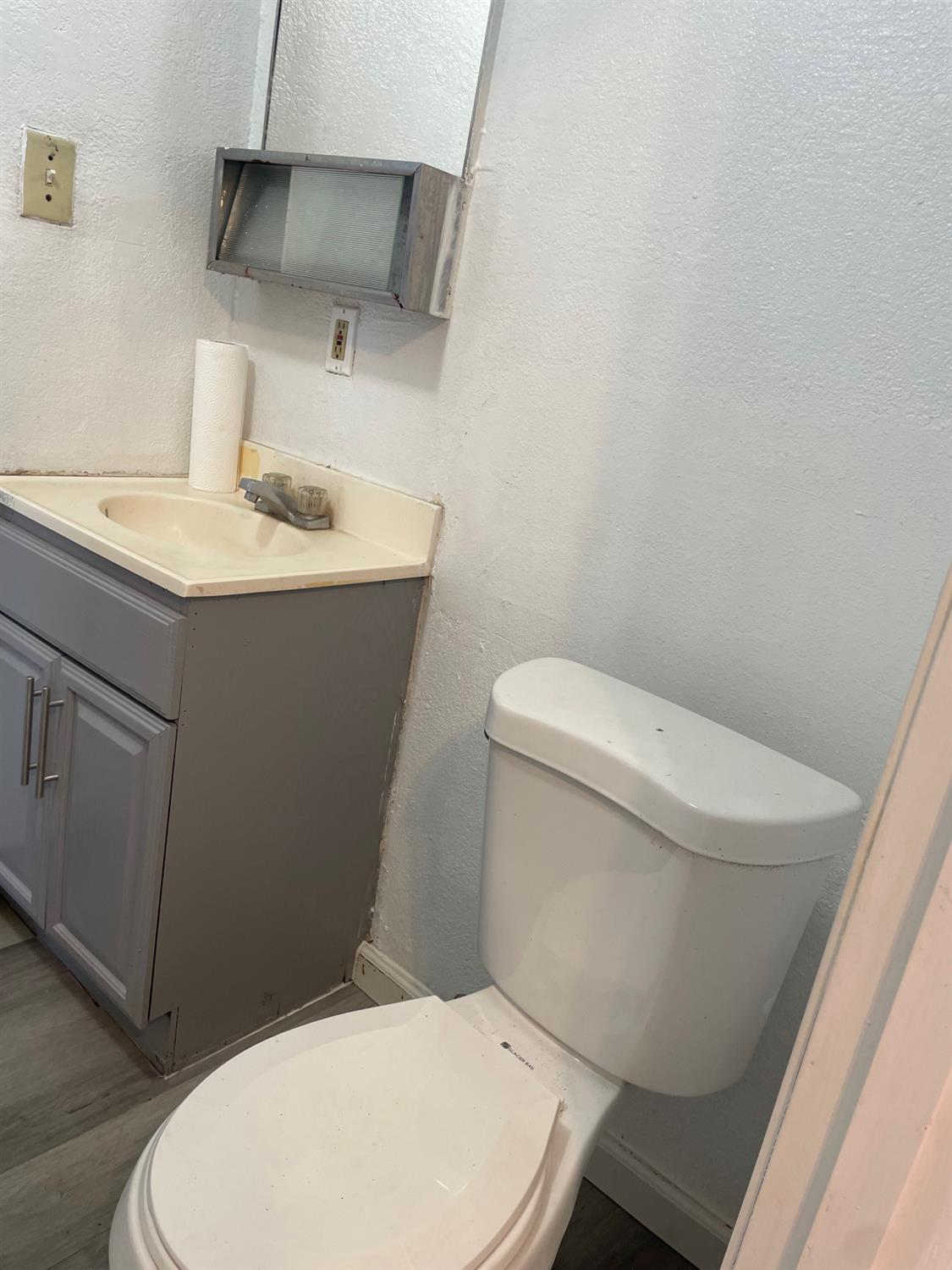 421 East Elm Street Lodi, CA 95240 - Photo 9 of 17 a white toilet sitting next to a bathroom sink