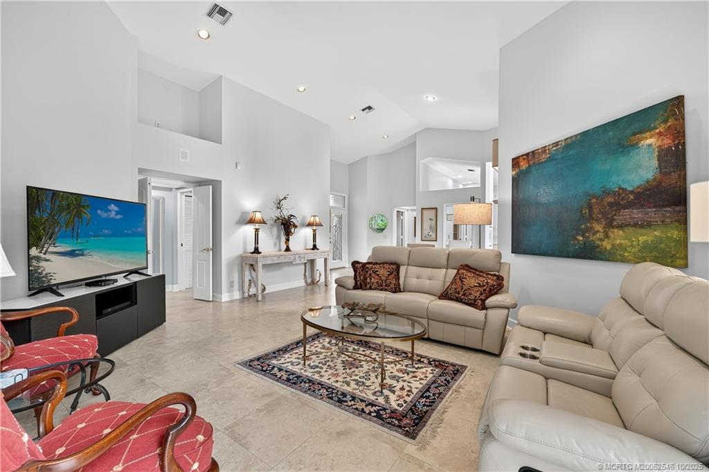 13009 Harbour Ridge Boulevard Palm City, FL 34990 - Photo 1 of 38 a living room with furniture and a flat screen tv