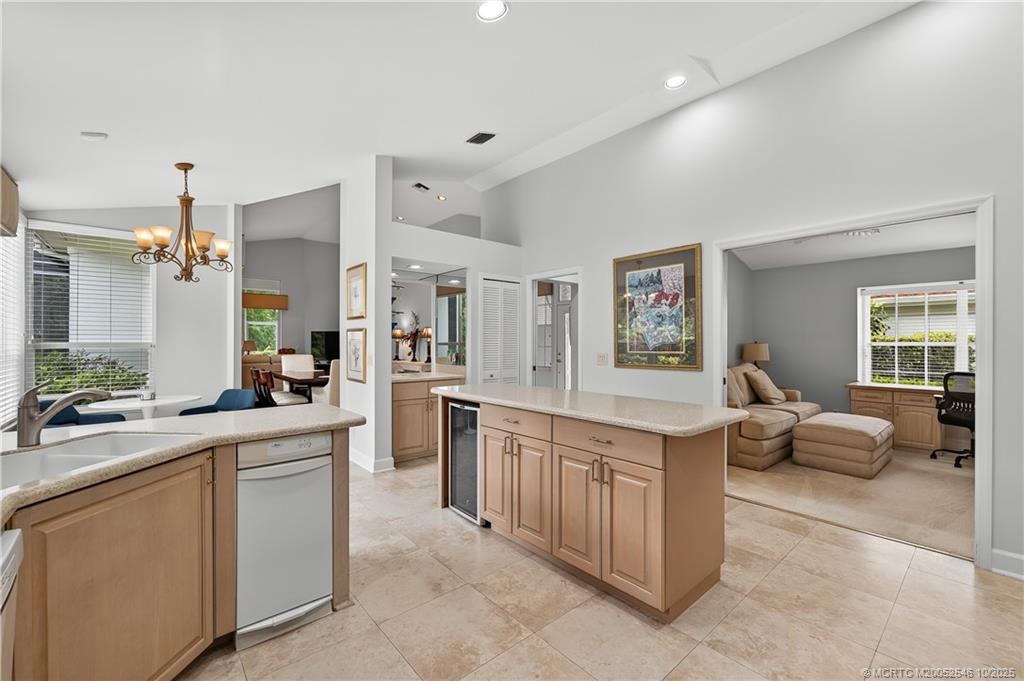 13009 Harbour Ridge Boulevard Palm City, FL 34990 - Photo 11 of 38 a large white kitchen with cabinets and chairs