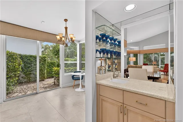 a view of a livingroom with furniture and floor to ceiling window