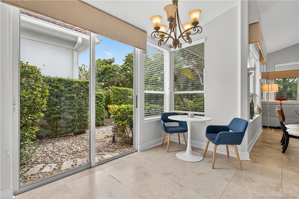 13009 Harbour Ridge Boulevard Palm City, FL 34990 - Photo 13 of 38 a view of a livingroom with furniture and floor to ceiling window
