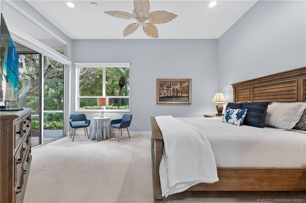 13009 Harbour Ridge Boulevard Palm City, FL 34990 - Photo 14 of 38 a bedroom with a bed and a large window