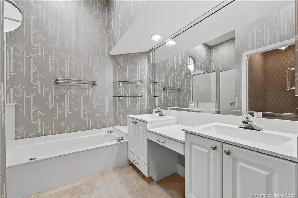 13009 Harbour Ridge Boulevard Palm City, FL 34990 - Photo 16 of 38 a bathroom with a double vanity sink mirror double and bathtub