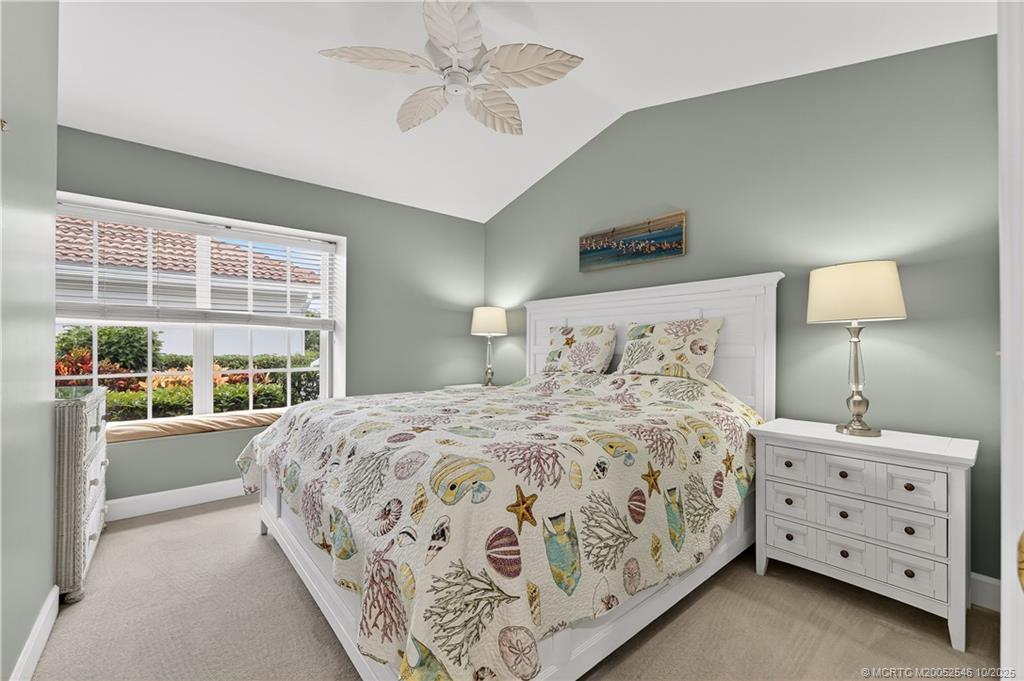 13009 Harbour Ridge Boulevard Palm City, FL 34990 - Photo 18 of 38 a bedroom with a large bed and a window