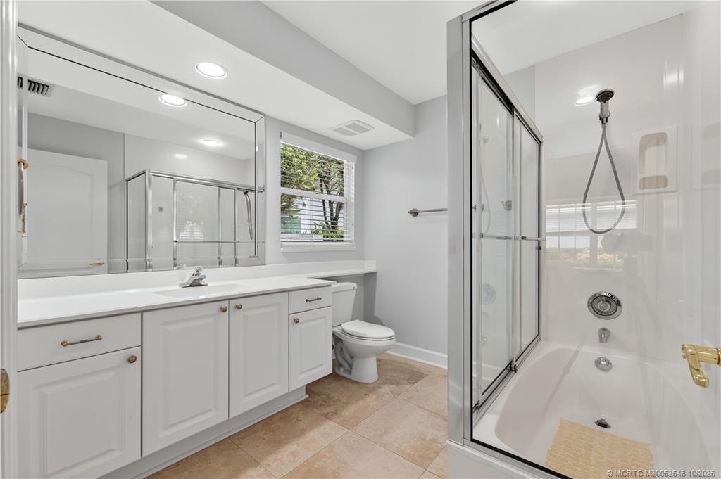 13009 Harbour Ridge Boulevard Palm City, FL 34990 - Photo 20 of 38 a spacious bathroom with a double vanity sink toilet and shower