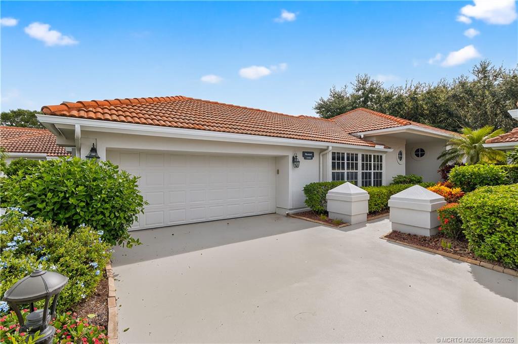 13009 Harbour Ridge Boulevard Palm City, FL 34990 - Photo 2 of 38 a view of a house with a patio