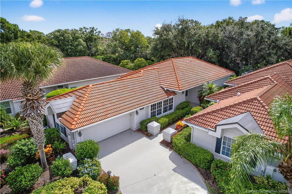 13009 Harbour Ridge Boulevard Palm City, FL 34990 - Photo 28 of 38 a aerial view of a house with a yard and a garden