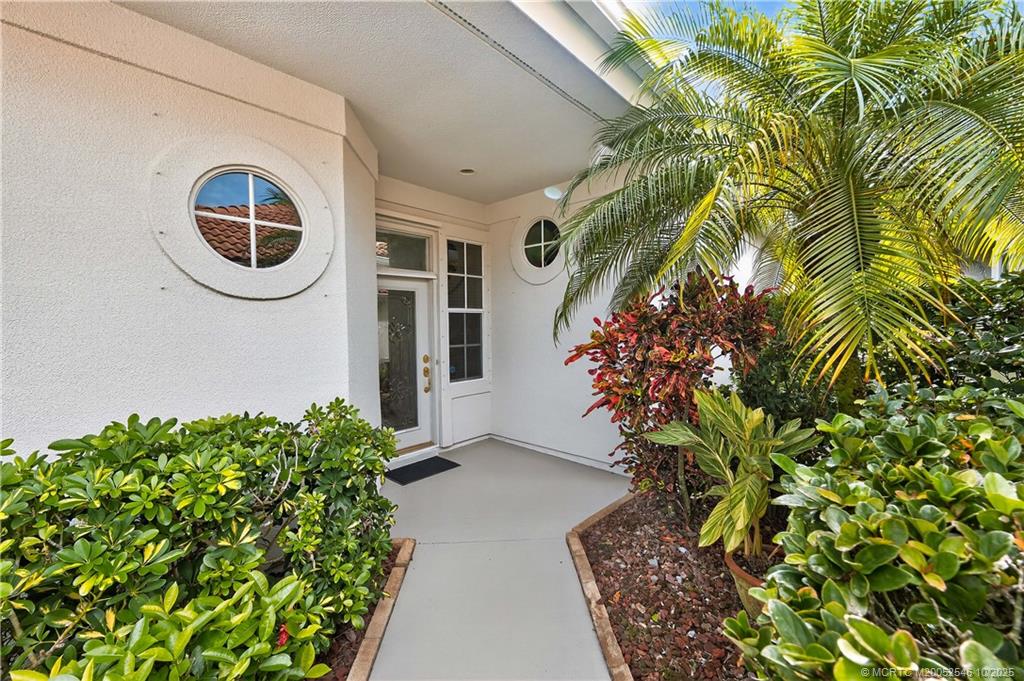 13009 Harbour Ridge Boulevard Palm City, FL 34990 - Photo 29 of 38 a front view of a house with garden