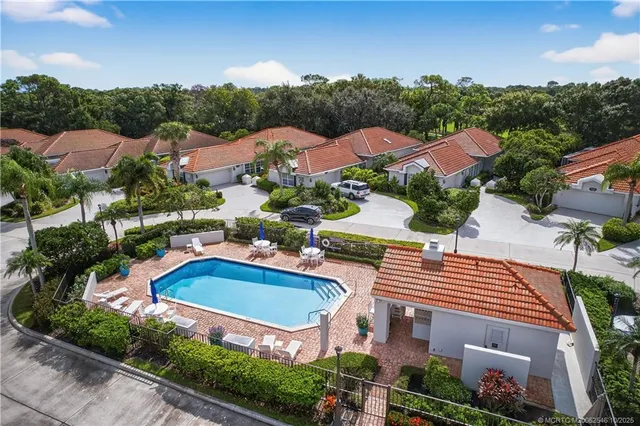 an aerial view of residential houses with outdoor space and street view