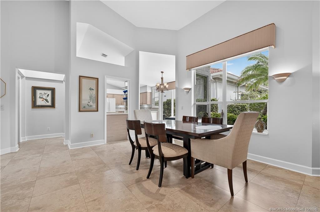 13009 Harbour Ridge Boulevard Palm City, FL 34990 - Photo 6 of 38 a view of a dining room with furniture window and wooden floor