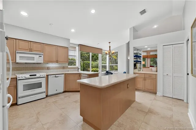 a kitchen with sink stove and refrigerator