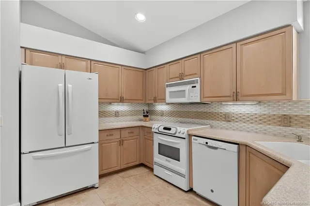 a white refrigerator freezer sitting inside of a kitchen