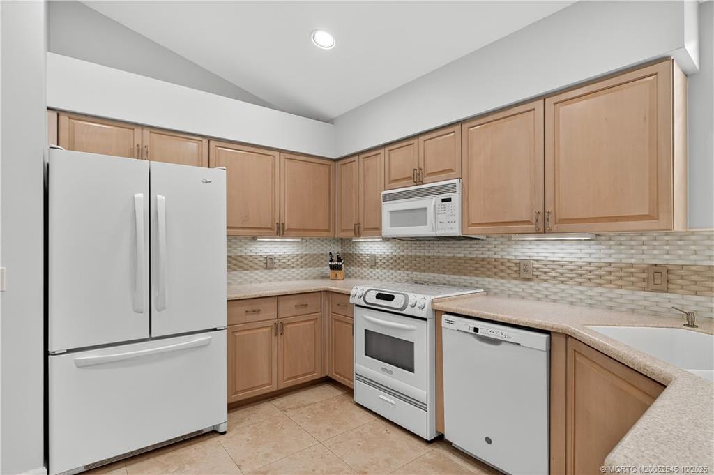 13009 Harbour Ridge Boulevard Palm City, FL 34990 - Photo 10 of 38 a white refrigerator freezer sitting inside of a kitchen