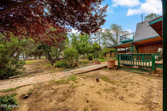 a view of a backyard with table and chairs and a fire pit