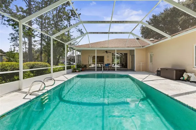 a view of a backyard with table and chairs