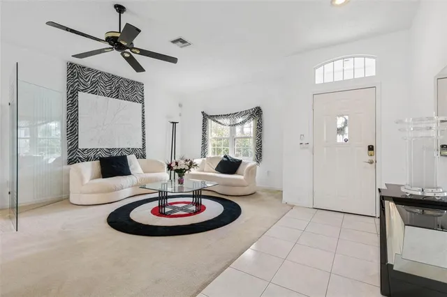a living room with furniture and a dining table