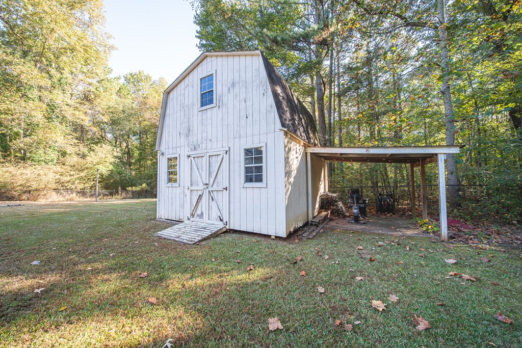 200 Lake Amah Lee Road Hampton, GA 30228 - Photo 5 of 29 a view of backyard with small cabin