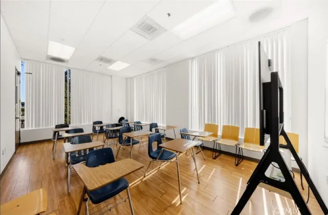 a living room with furniture and large windows