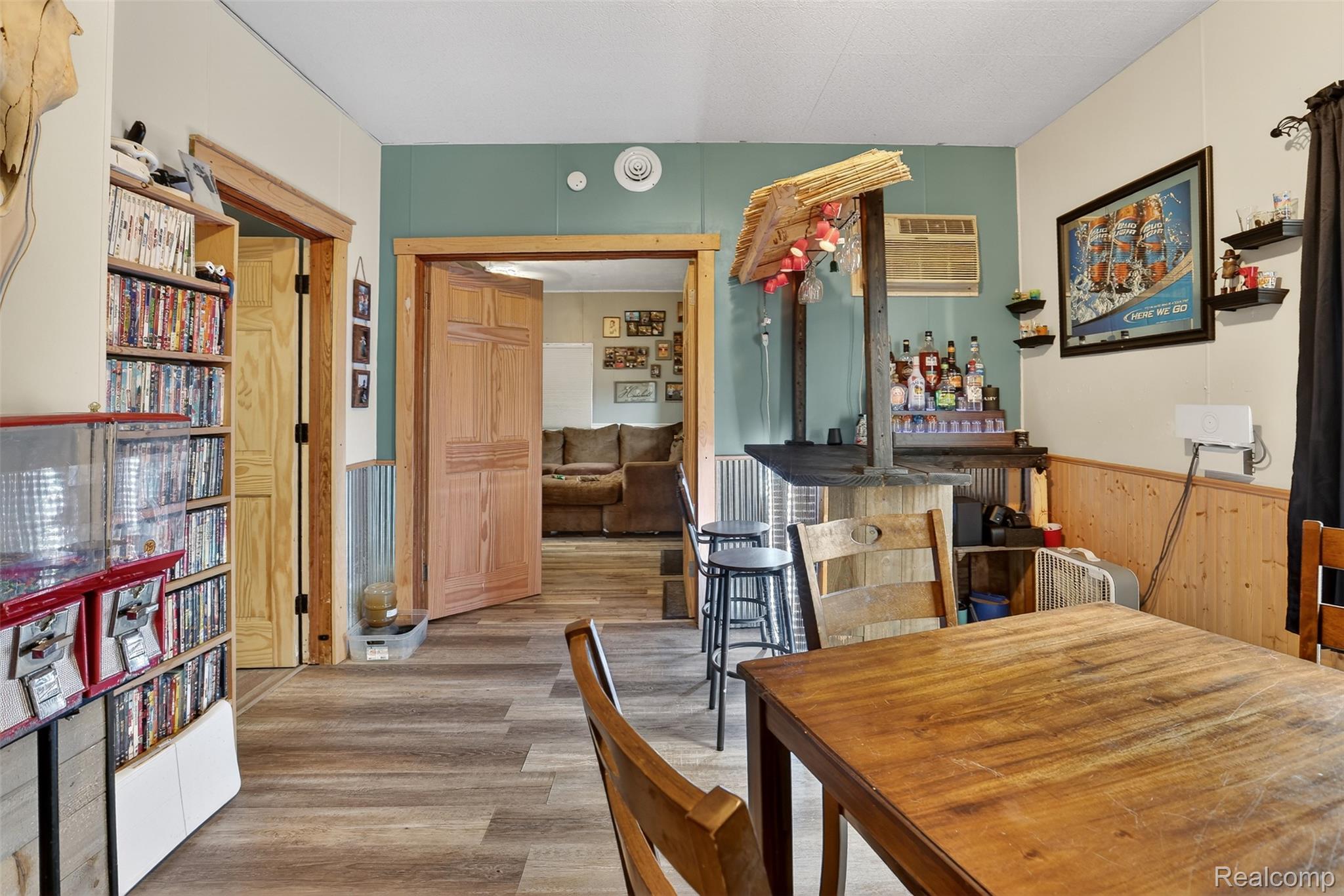 5639 Swaffer Road Millington, MI 48746 - Photo 8 of 25 Dining area featuring light wood-style flooring, wainscoting, and wood walls