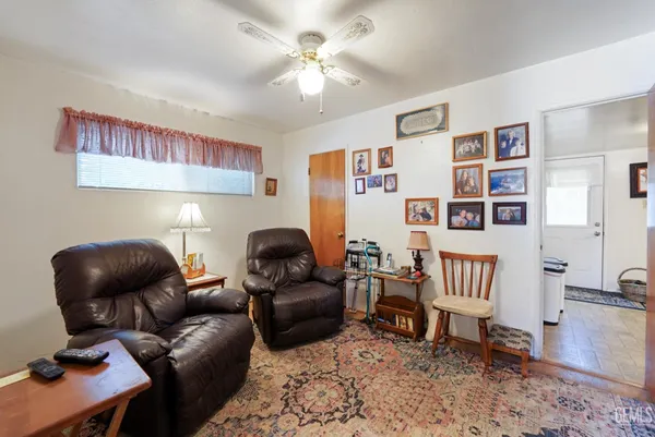 a living room with furniture and a book shelf