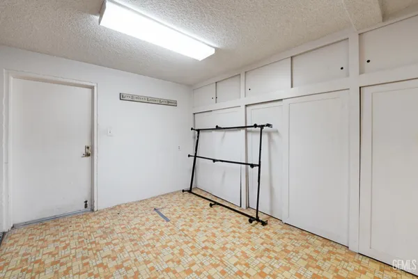 a living room with a couch and a dining table with wooden floor