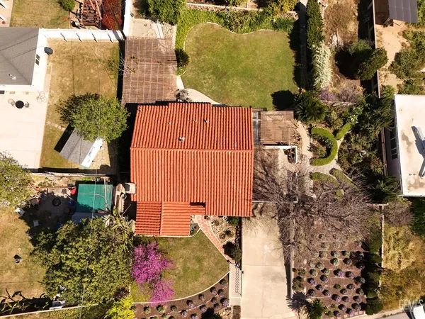 a view of a house with a yard and sitting area